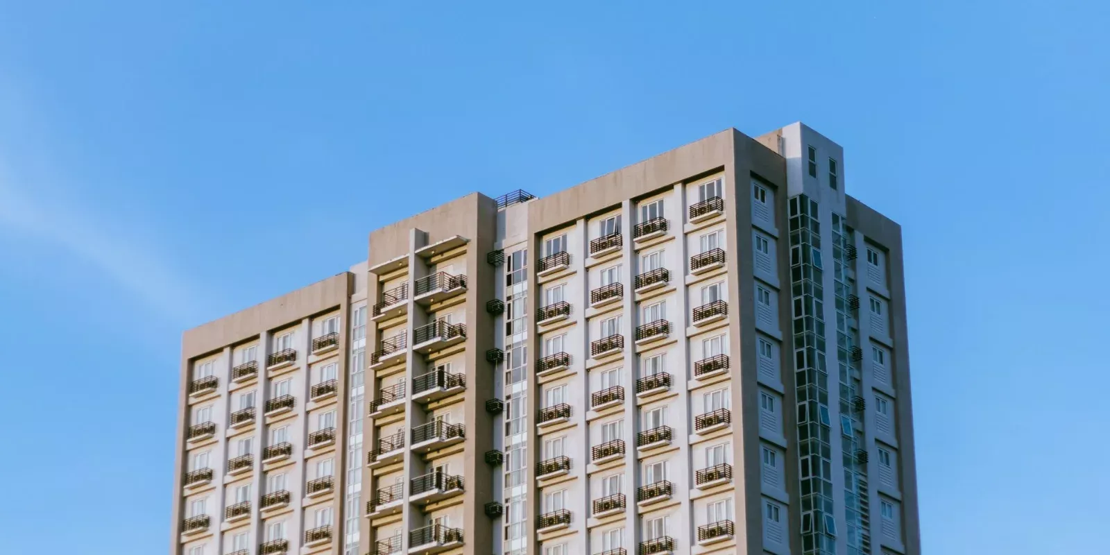 Edificio residencial de condominios con balcones bajo cielo despejado
