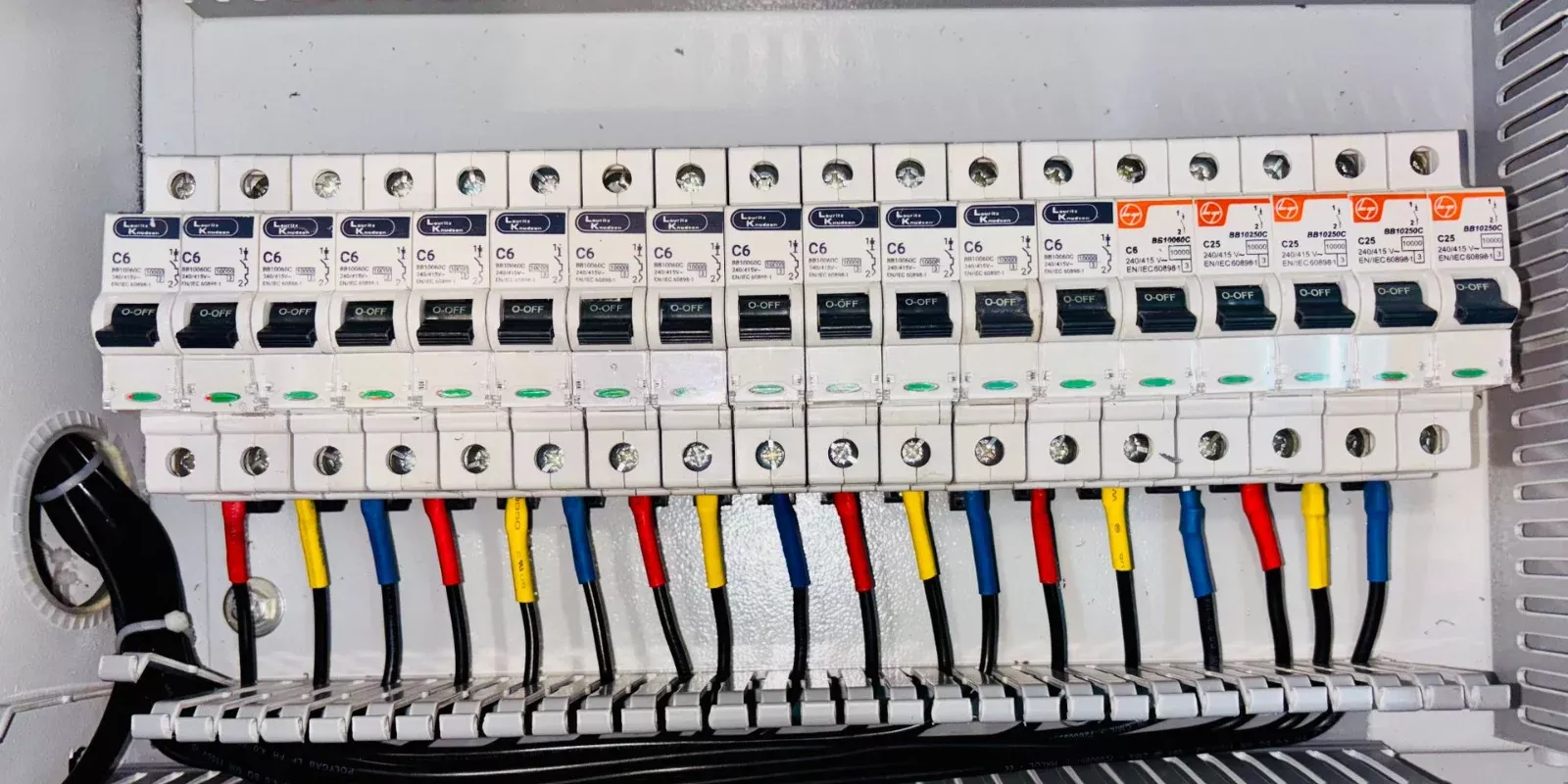 Panel de interruptores eléctricos abierto con el cableado a la vista